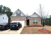 Charming single-Gathering home featuring brick facade, well-maintained lawn, and attached garage at 1125 Campbell Pine Trl, Lawrenceville, GA 30045