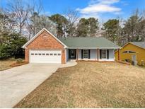 Charming single-story home with brick accents and a two-car garage at 2412 Cheyenne Ln, Lawrenceville, GA 30044