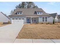 Charming single-story home with welcoming front porch, two-car garage, and well-maintained lawn at 30 Foothills Trl, Sharpsburg, GA 30277