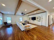 Spacious living room features hardwood floors, exposed beams, and custom built-ins at 827 Derrydown Way, Decatur, GA 30030