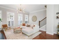 Bright living room with modern light fixture, comfortable seating, and large windows at 1800 Morning Glory Ne Ln, Atlanta, GA 30324