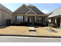 Charming one-story home featuring a manicured front yard and welcoming entrance at 317 Glens Way, Woodstock, GA 30188