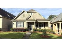 Charming single-Gathering home featuring craftsman architecture, a manicured lawn, and beautiful shrubbery at 317 Glens Way, Woodstock, GA 30188