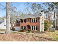 Charming two-story brick home with attached garage and well-maintained landscaping at 105 Terrace Tay, Peachtree City, GA 30269