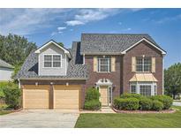 Beautiful brick two-story home with a well-manicured lawn and a two-car garage in a quiet neighborhood at 3370 Flagstone Trce, Ellenwood, GA 30294
