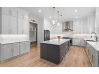 This kitchen features white cabinets, stainless steel appliances, and a large center island, perfect for cooking and entertaining at 4827 Basingstoke Dr, Suwanee, GA 30024