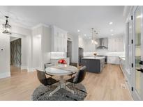 Bright kitchen featuring white cabinetry, stainless appliances, and a center island with bar seating at 4827 Basingstoke Dr, Suwanee, GA 30024