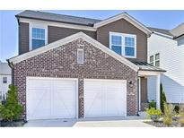 Charming two-story home features a two-car garage, brick accents, and well-maintained landscaping at 3928 Hester St, Duluth, GA 30097