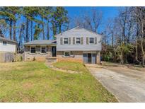 Charming two-story home with a traditional design and a well-maintained front yard at 6050 Randy Ln, Ellenwood, GA 30294