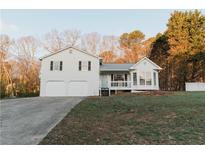 Charming two-story home featuring a large front yard, attached garage, and inviting front porch at 297 Graison Ln, Dallas, GA 30157