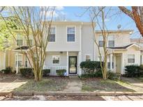 Charming two-story townhome with a welcoming front porch and mature landscaping creating an inviting curb appeal at 2376 Wellington Cir, Lithonia, GA 30058
