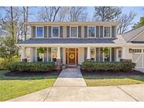 Charming two-story home with a welcoming front porch, neat landscaping, and a lovely wood front door at 3932 Sentry Walk, Marietta, GA 30068