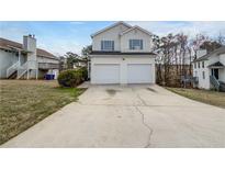 Charming two-story home featuring a two-car garage and traditional architectural details at 1486 Waterton Trl, Douglasville, GA 30134
