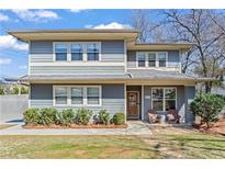 Charming two-story home with a front porch and landscaped yard offers a welcoming curb appeal at 305 Norwood Ne Ave, Atlanta, GA 30317