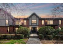 Beautiful condo building with brick facade and updated black and white trim and balcony at 6851 Roswell Rd # F36, Atlanta, GA 30328