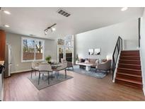 Spacious living room featuring high ceilings, lots of natural light, and modern staircase with metal railings at 1342 Rietveld Nw Row, Atlanta, GA 30318