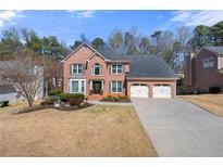 Charming two-story brick home with a well-manicured lawn and a two-car garage at 922 Grandview Nw Way, Acworth, GA 30101