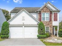 Charming two-story home with a stone accent and a well-manicured front yard with mature trees at 3246 Wellington Sw Walk, Atlanta, GA 30331