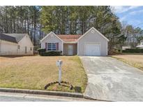 Charming single-story home featuring a one car garage and a well-maintained lawn at 6187 Harvard Ct, Morrow, GA 30260