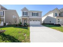 Charming two-story home with a brick and siding exterior and a well-manicured lawn at 11844 Rizvan Pl, Covington, GA 30014