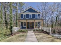 Charming two-story home with a welcoming front porch and beautifully landscaped front yard at 1889 Felker Ward Nw St, Atlanta, GA 30318