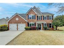 Charming brick home with a well-manicured lawn and a two-car garage, showcasing classic suburban living at 245 Davenham Ct, Alpharetta, GA 30005