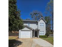 Charming two-story home with a one-car garage, neat landscaping, and a well-maintained front yard at 2870 Pebblebrook Ct, Buford, GA 30518