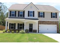 Charming two-story home with a welcoming front porch, attached garage, and well-maintained lawn at 83 Nyishol Way, Dallas, GA 30157
