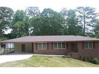Charming single-story brick home with a carport and well-manicured front lawn at 4643 Wesley Dr, Austell, GA 30106