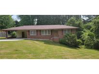 Charming one-story brick home with well-maintained lawn and covered parking at 4643 Wesley Dr, Austell, GA 30106
