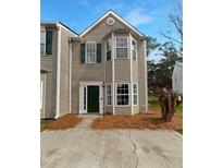 Charming two-story home features a classic design with neutral siding and well-maintained landscaping in the front at 45 Hampton Dr, Cartersville, GA 30121