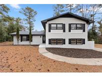 Charming two-story home with white brick, black trim, and a neatly landscaped front yard at 2158 Oregon Ct, Decatur, GA 30032