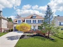 Charming two-story home with a well-manicured lawn, colorful tree and inviting front porch at 3530 Horizon Ct, Cumming, GA 30041