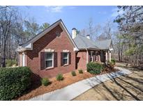 Charming one-story brick home with manicured landscaping and inviting walkway at 9246 W Banks Mill Rd, Winston, GA 30187