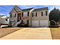 Charming two-story home with a stone facade and a two-car garage at 252 Berkley Dr, Villa Rica, GA 30180