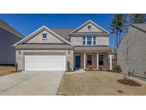 Charming two-story brick home with a manicured lawn, attached two-car garage, and welcoming front porch at 1236 Maston Rd, Auburn, GA 30011