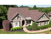 Charming home featuring a stone facade, landscaped yard, and a well-maintained lawn at 11 York Trce, Cartersville, GA 30121