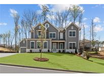 Beautiful two-story home featuring gray siding, white trim, and a well-manicured lawn at 1975 Sage Lake Bend Sw, Marietta, GA 30064