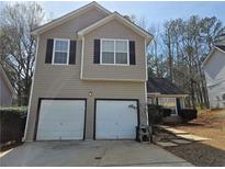 Two story home featuring an attached two car garage, black shutters, and a driveway at 4183 Ward Lake Trl, Ellenwood, GA 30294