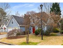 Charming two-story home with a well-maintained lawn, a two-car garage, and an inviting red front door at 2859 Royal Blf, Decatur, GA 30030