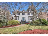 Charming two-story home with dormer windows, a well-manicured lawn and mature trees at 930 Camden Hill Ct, Lawrenceville, GA 30046