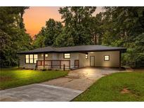 Charming brick home featuring a spacious carport and welcoming front porch at 2403 Dawn Dr, Decatur, GA 30032