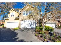 Charming two-story home featuring a two-car garage and beautifully landscaped front yard with mature tree at 4541 Wieuca Ne Rd, Atlanta, GA 30342