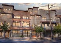 Stunning brick building featuring large windows and wrought iron accents, all set against a beautiful street view at 1199 Huff Nw Rd # 112, Atlanta, GA 30318