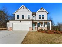 Charming two-story home features a two-car garage, inviting front porch, and pristine lawn at 20 Running Nw Ter, Cartersville, GA 30121