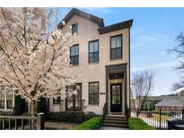 Charming two-story home featuring a blooming tree, manicured landscaping, and a welcoming front entrance at 4336 Walsh Dr, Dunwoody, GA 30338