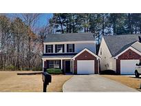 Charming two-story home features a brick-accented garage and a well-maintained front yard at 525 Hillandale Park Dr, Lithonia, GA 30058