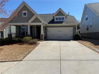 Charming single-Gathering home with a two-car garage and a welcoming front porch at 410 Windy Ridge Way, Canton, GA 30114