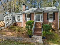 Charming brick home with inviting front steps, black shutters, and well-maintained landscaping at 1201 Thomas Rd, Decatur, GA 30030