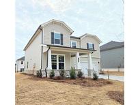 Charming two-story home featuring a welcoming front porch and classic architectural details at 2624 Mourning Dove Drive (Lot 42), Grayson, GA 30017